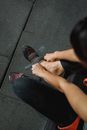 Crop faceless person putting on sneakers