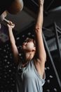 Determined woman hanging on gym equipment