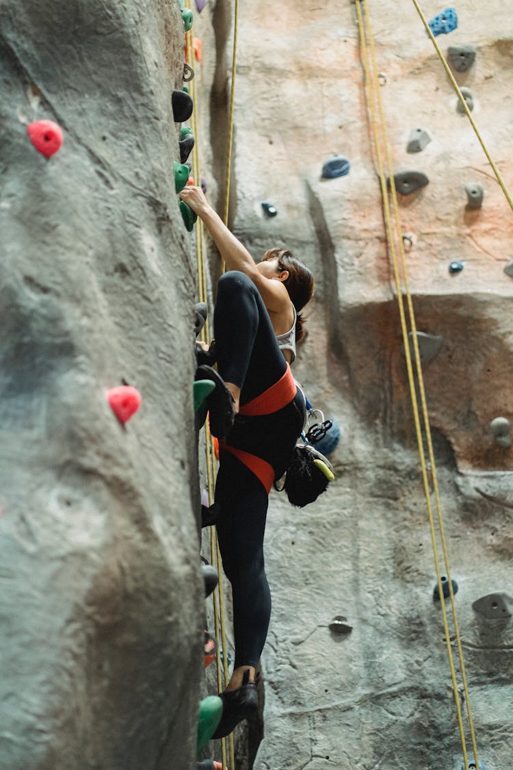 Strong Woman Training On Climbing Wall