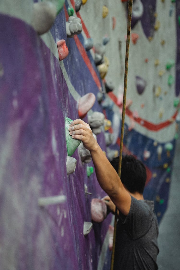 Anonymous Climber Practicing Bouldering In Gym