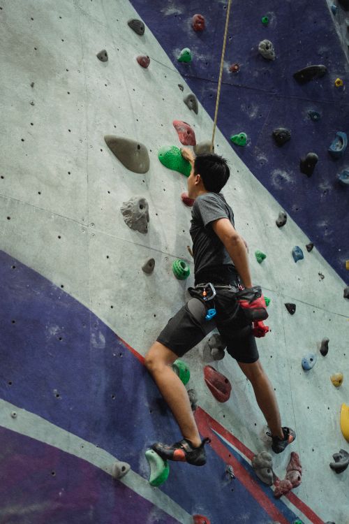 Free Low angle of unrecognizable man with belay training on climbing wall during workout Stock Photo