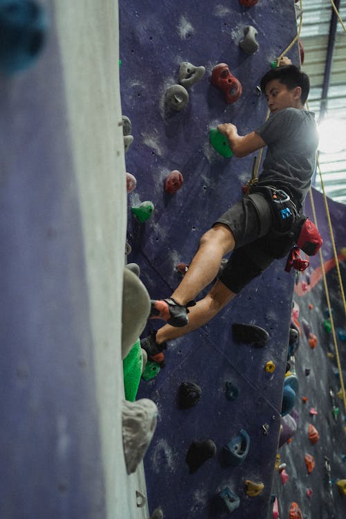 Free Young athlete on climbing wall Stock Photo