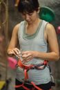 Crop female climber putting plasters on fingers for climbing training