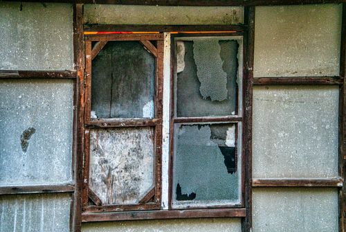 Free A decayed wooden window with broken glass in an urban setting, evoking a rustic charm. Stock Photo
