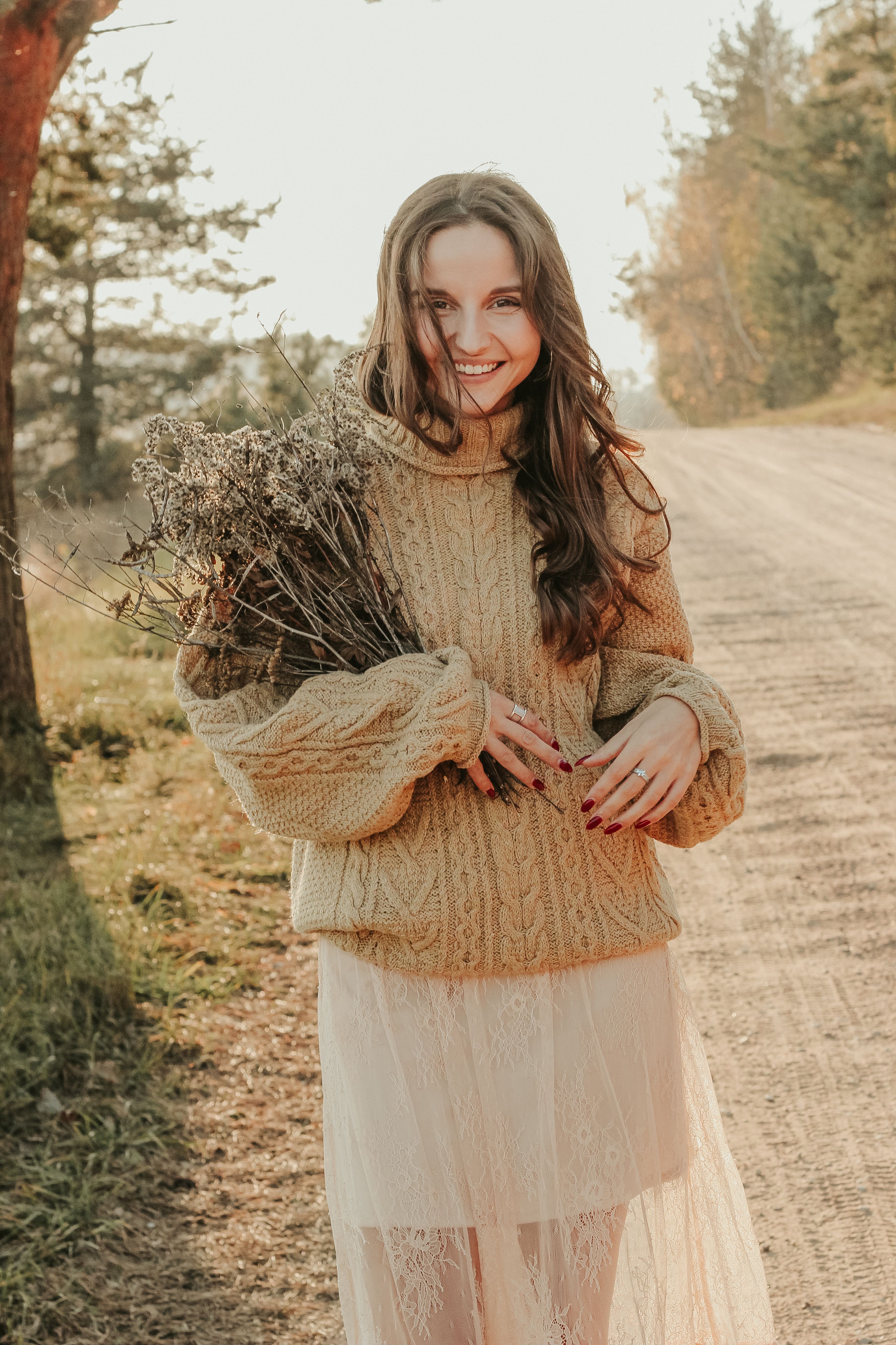 Woman in Brown Knit Sweater Sitting on Brown Grass Field · Free Stock Photo