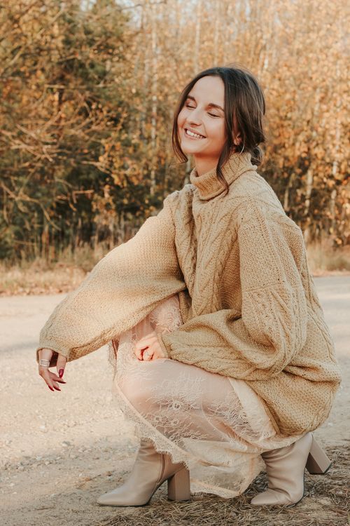 woman in gray sweater dress with slouchy brown knee-high boots