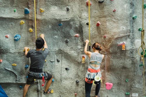 Anonymous strong climber ascending wall in gym