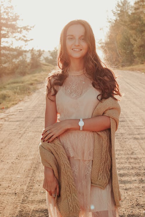 A Beautiful Woman Wearing White Dress and Brown Knitted Sweater