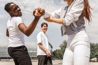 Joyful multiethnic friends having fun together on city square