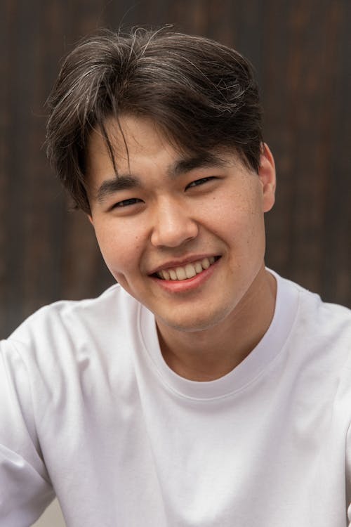 Handsome young ethnic guy looking at camera and smiling