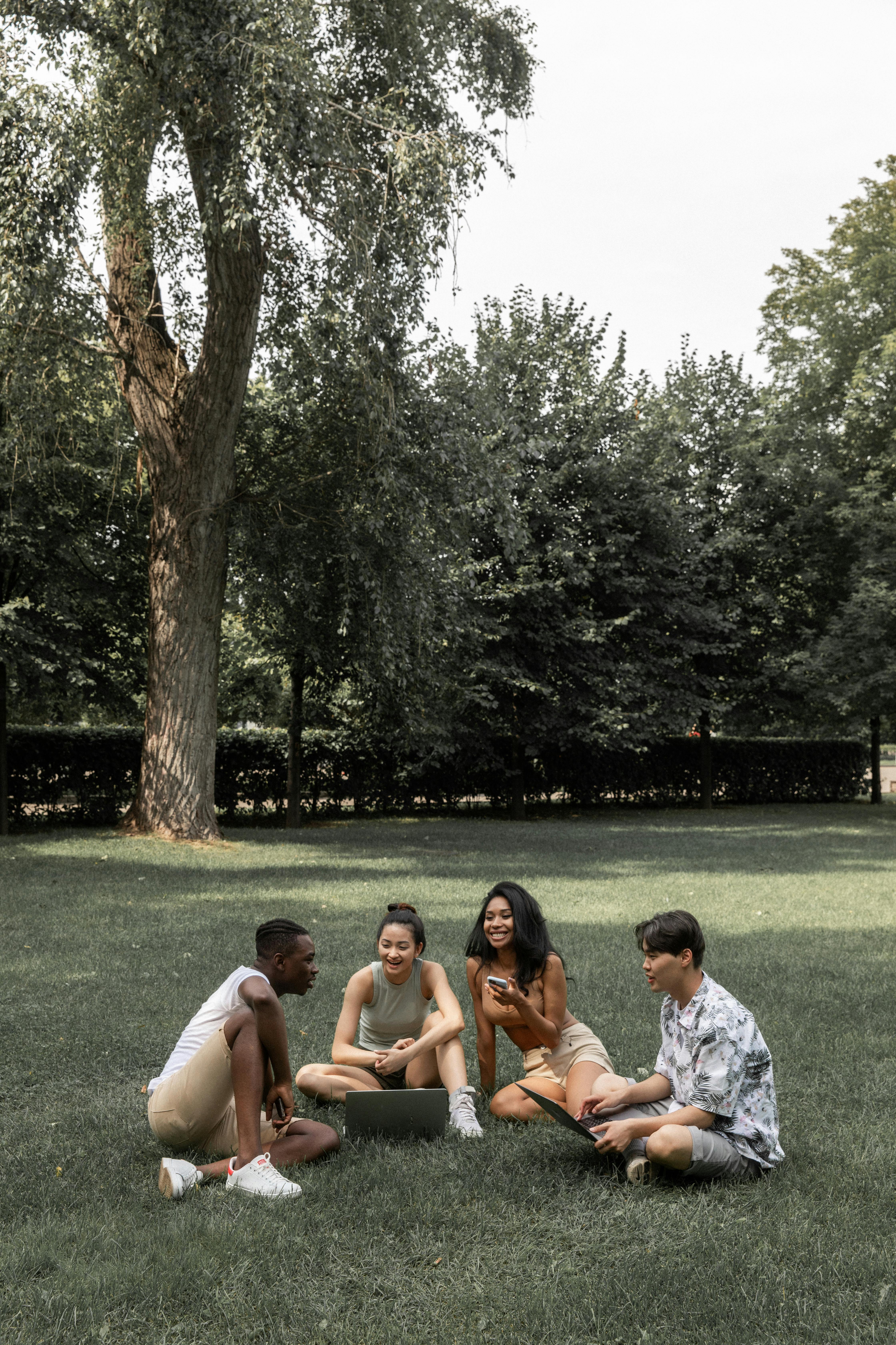 multiracial friends gathering in summer park