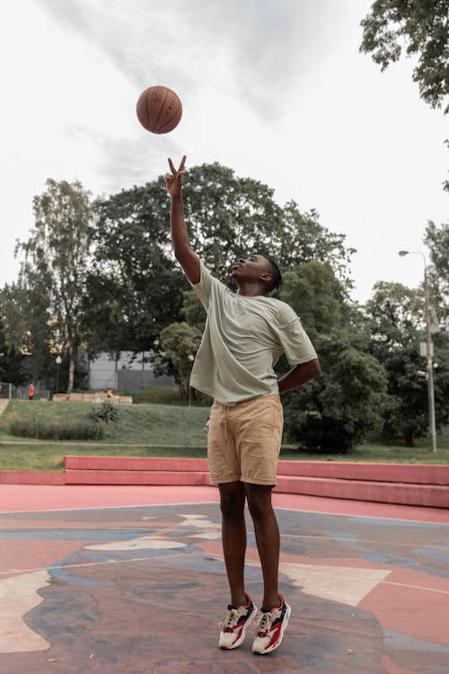 Black man playing basketball on court