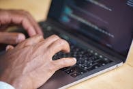 Hands Typing on a Laptop Computer