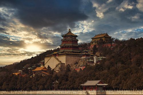 Free Breathtaking sunset over the historic Summer Palace, showcasing its stunning architecture and serene landscape. Stock Photo