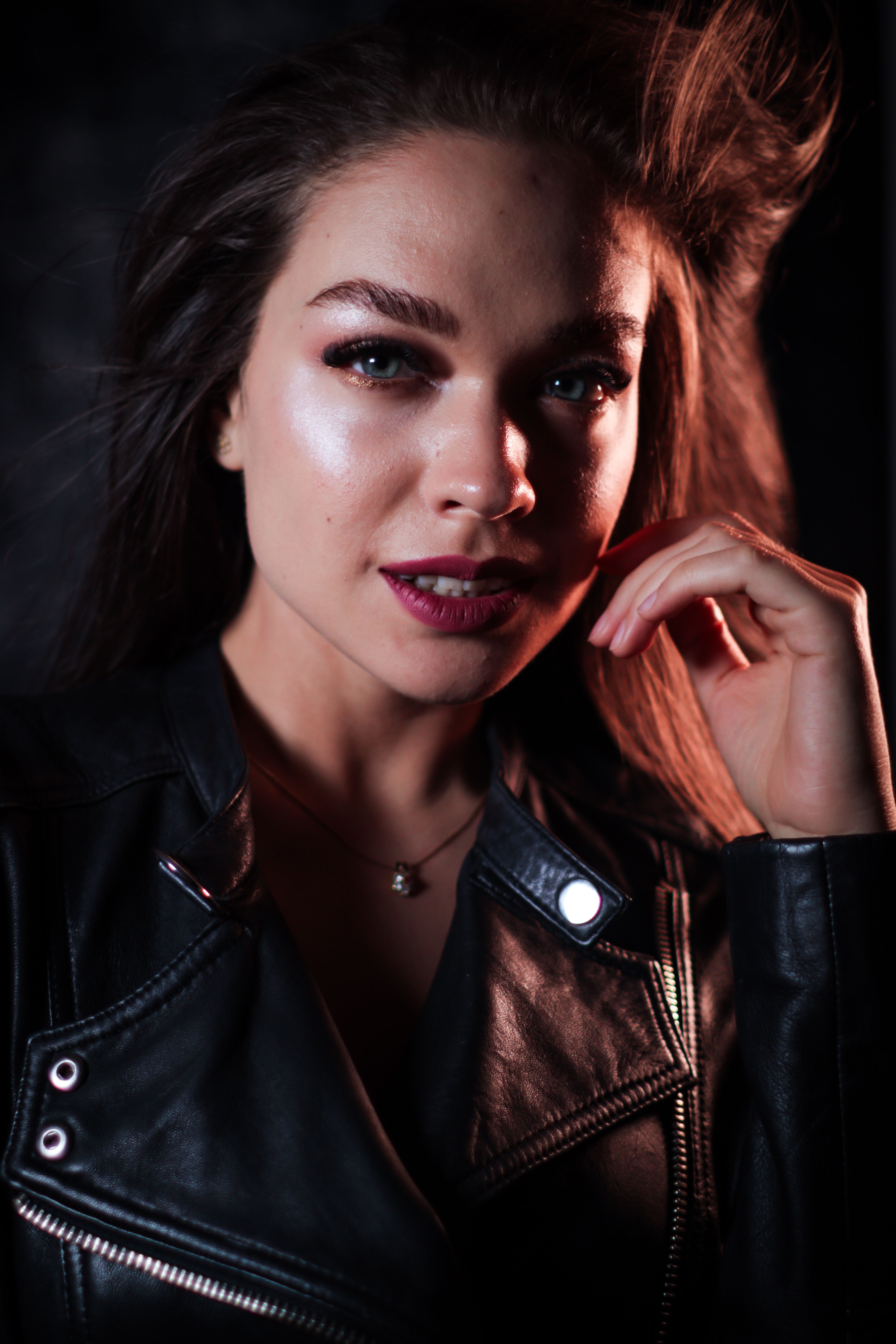 Woman in black leather jacket studio portrait