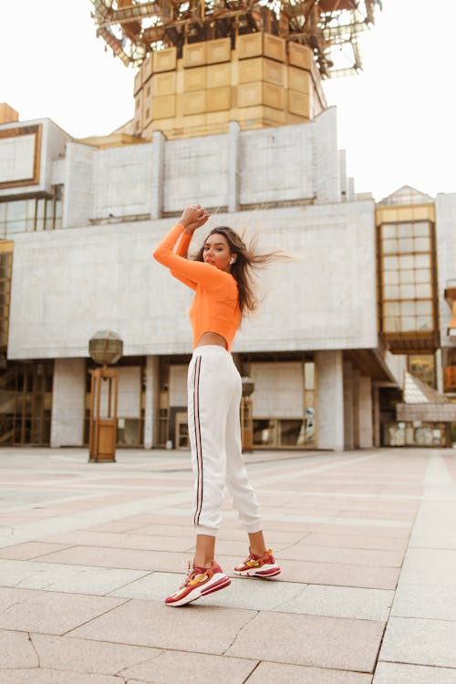 Woman Dancing Wearing White and Red Nike Rubber Shoes 