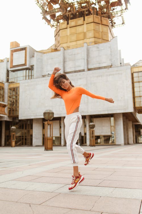 Woman Jumping with her Arm Raised 