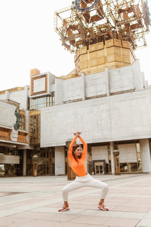 Woman Dancing with Her Hands Above Her Head 