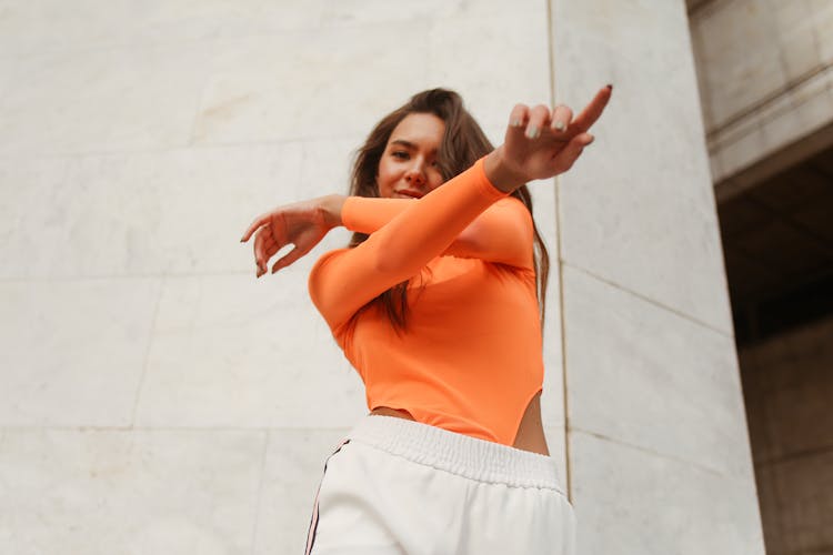 Woman In Orange Shirt Dancing