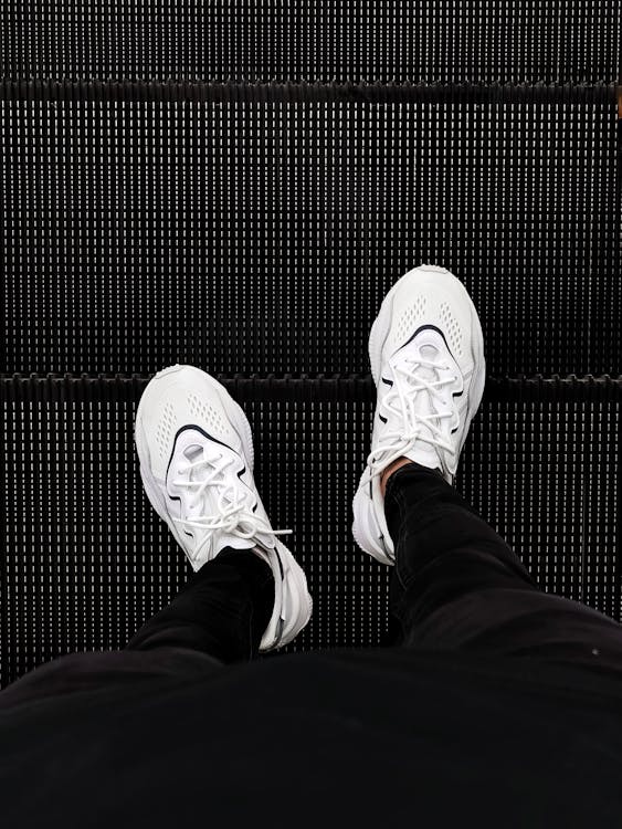 A Person Wearing a Stylish White Sneakers · Free Stock Photo