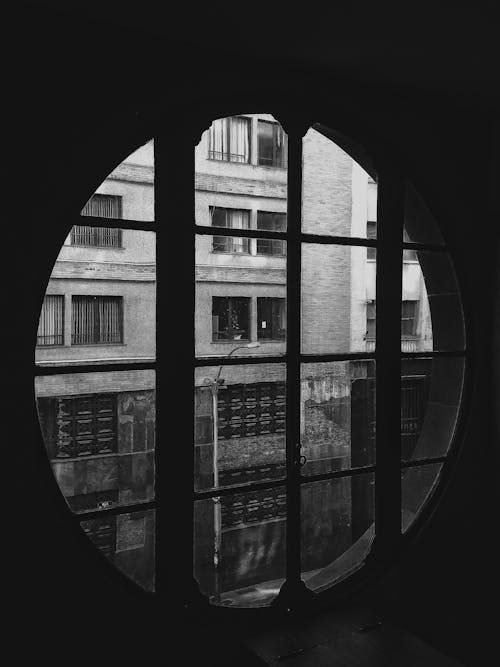 Grayscale Photo of Round Glass Windows