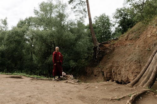 Buddhist Monk Praying in Wilderness
