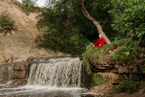 Buddhist Monk Sitting by Cascade