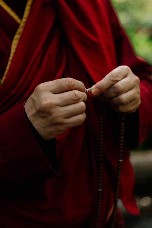 Tibetan Buddhist Monk Praying on Beads
