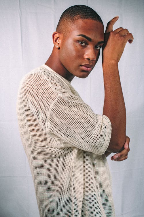 Stylish black man with focused gaze on white background