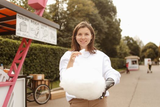 Young Woman with Prosthetic Arm Eating Candy Floss