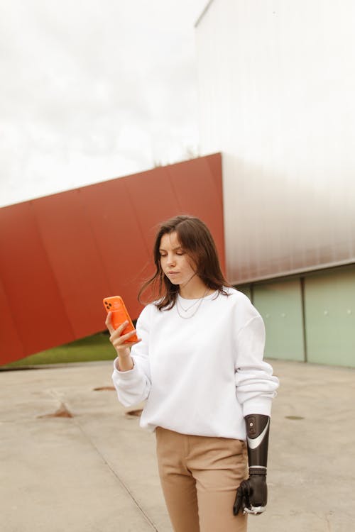 Woman With a Prosthetic Hand Using her Smartphone