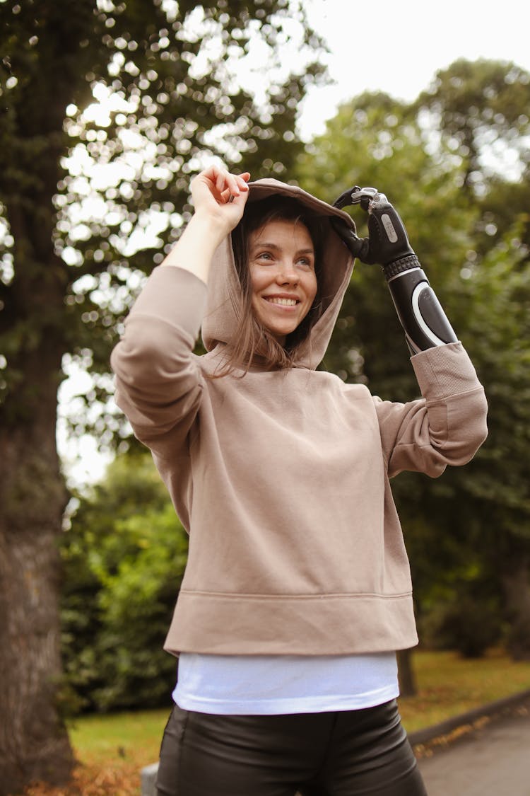 Woman With Prosthetic Hand In A Hoodie