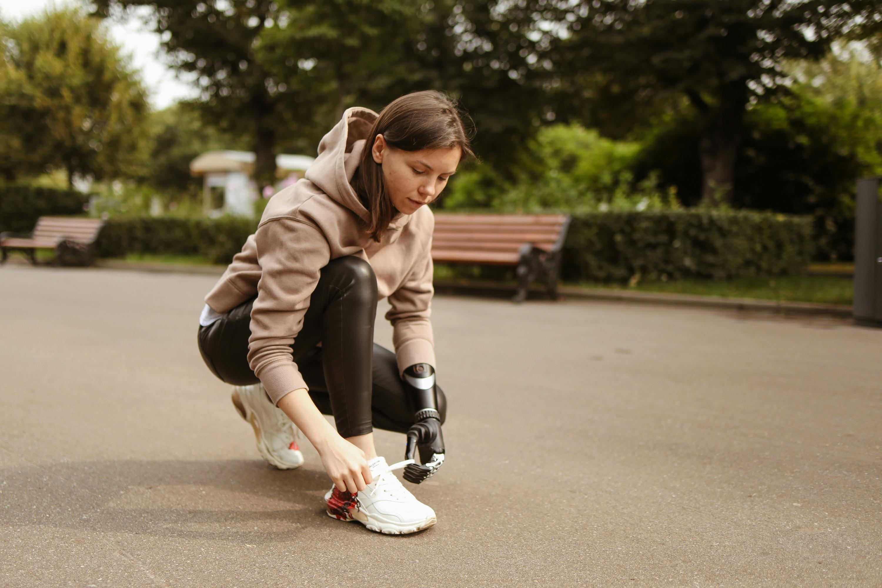Person tying shoelaces while looking at a timer with a determined expression