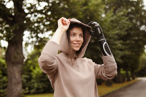 Woman in Brown Sweater Holding her Hoodie