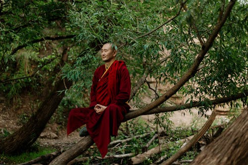 Man in Red Long Sleeve Dress Meditating