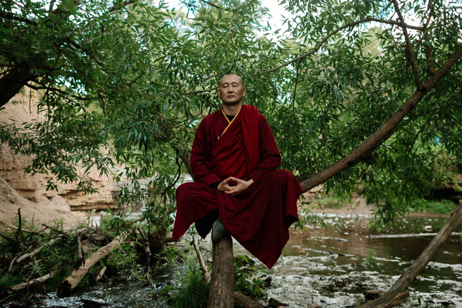 A person meditating peacefully outdoors in nature during a guided meditation practice