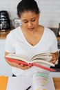 Woman in White V Neck Shirt Reading Book