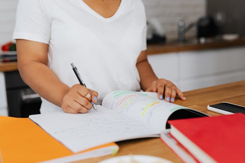 Free Woman Writing in a Notebook  Stock Photo