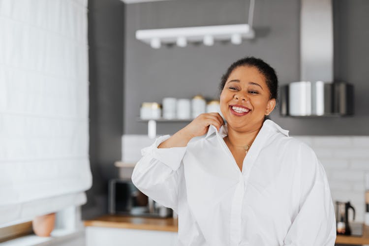 A Woman In A White Polo Smiling