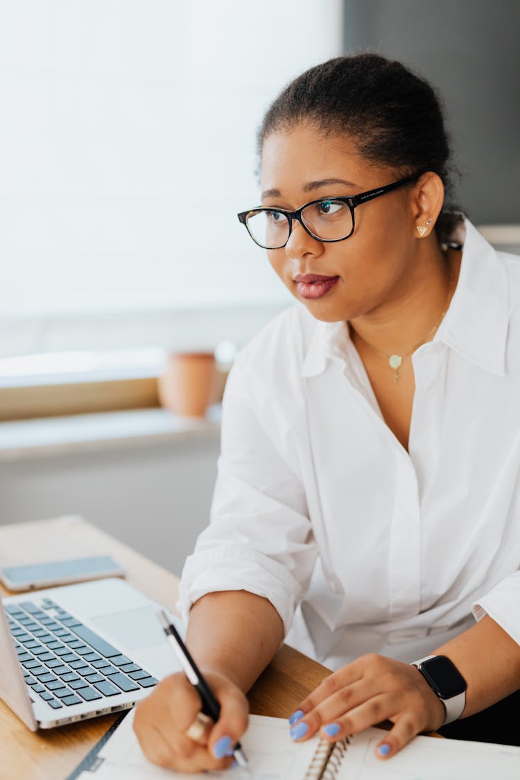 Woman In White Button Up Shirt Writing On Notebook