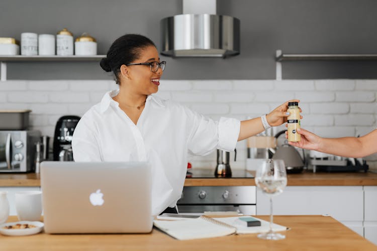 Woman In White Top Holding A Drink