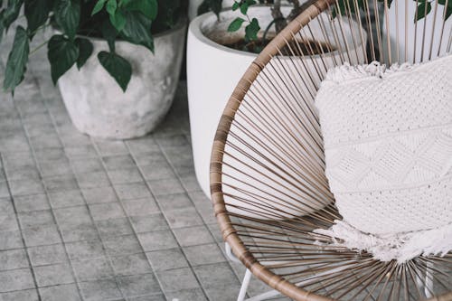 A White Pillow on a Wicker Chair