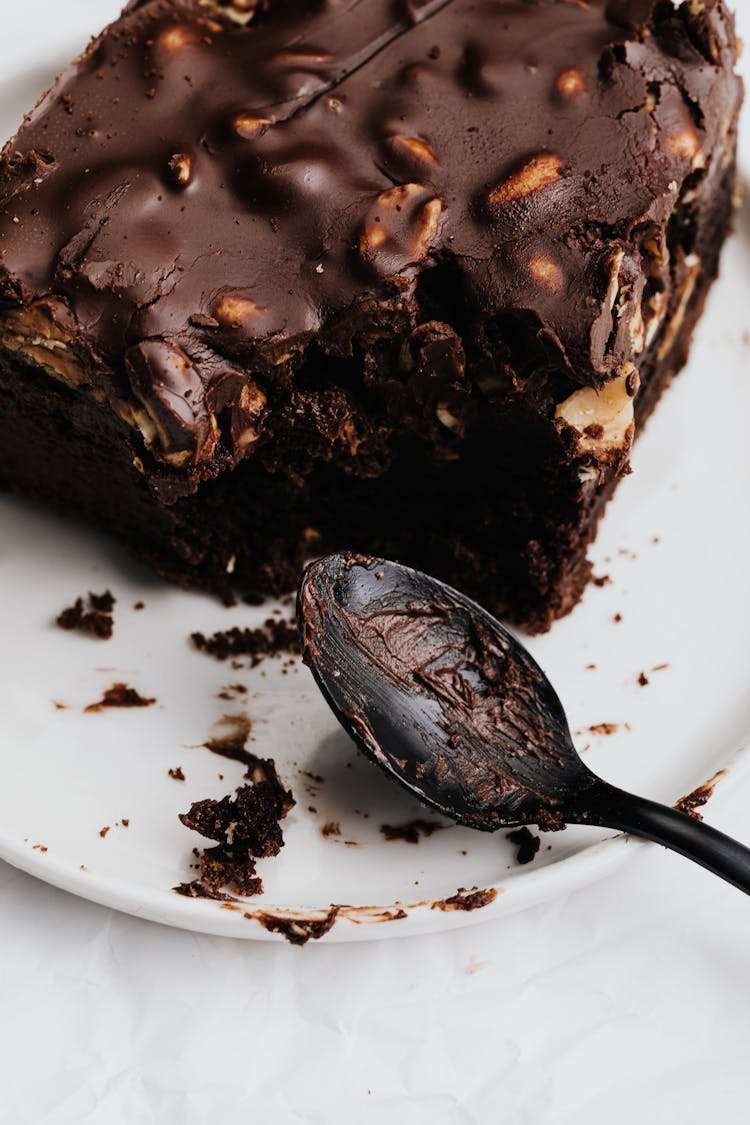 Slice Of Chocolate Brownie On White Ceramic Plate