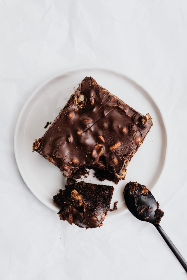 Slice Of Chocolate Brownie On White Ceramic Plate