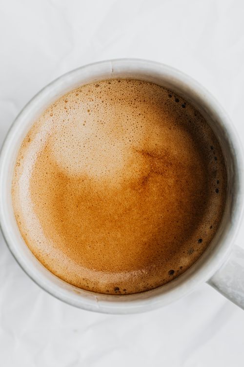 Free Artistic top view of a steaming cup of coffee with rich, creamy foam, perfect for morning energy. Stock Photo