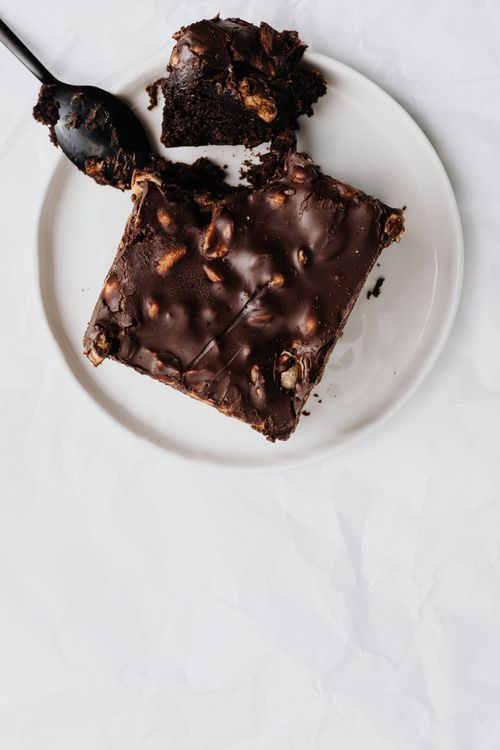 Free Top-down view of a rich chocolate dessert with nuts on a plate, perfect for indulgence. Stock Photo