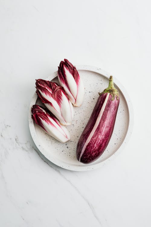 Free Flower Heads and Eggplant on Plate Stock Photo
