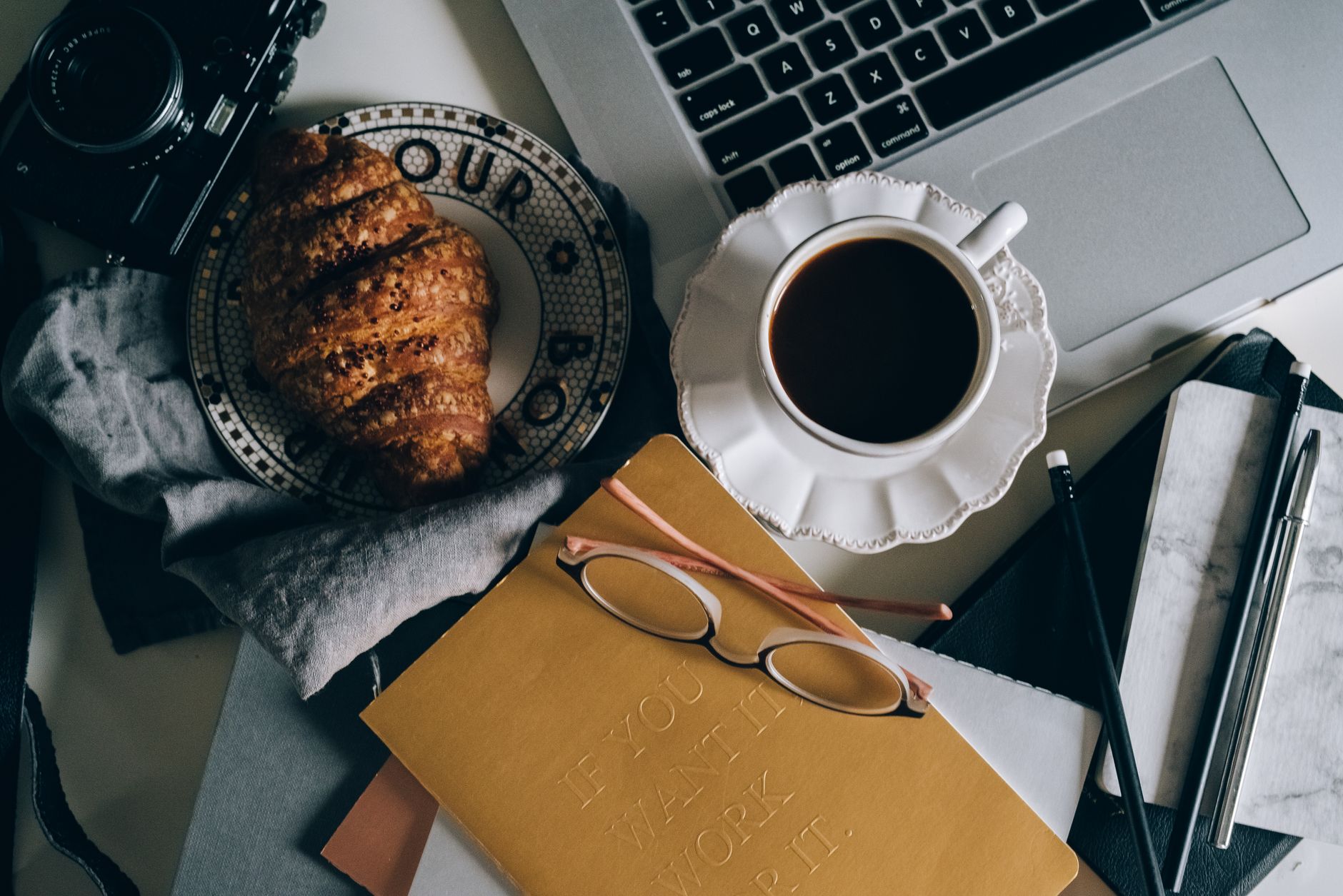 Croissant on a Plate and a Cup of Black Coffee