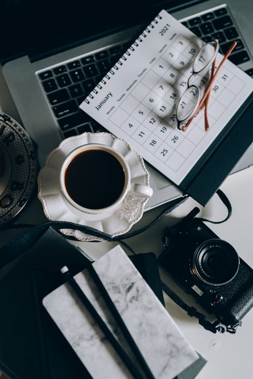Free Cup of Black Coffee Beside a Calendar Stock Photo