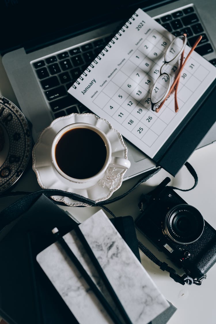 Cup Of Black Coffee Beside A Calendar